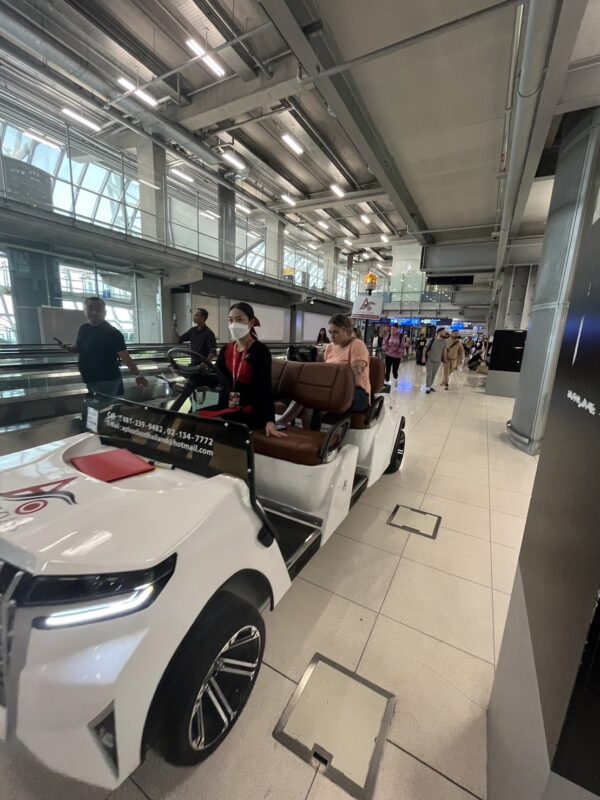 airport buggy with airport welcome staff